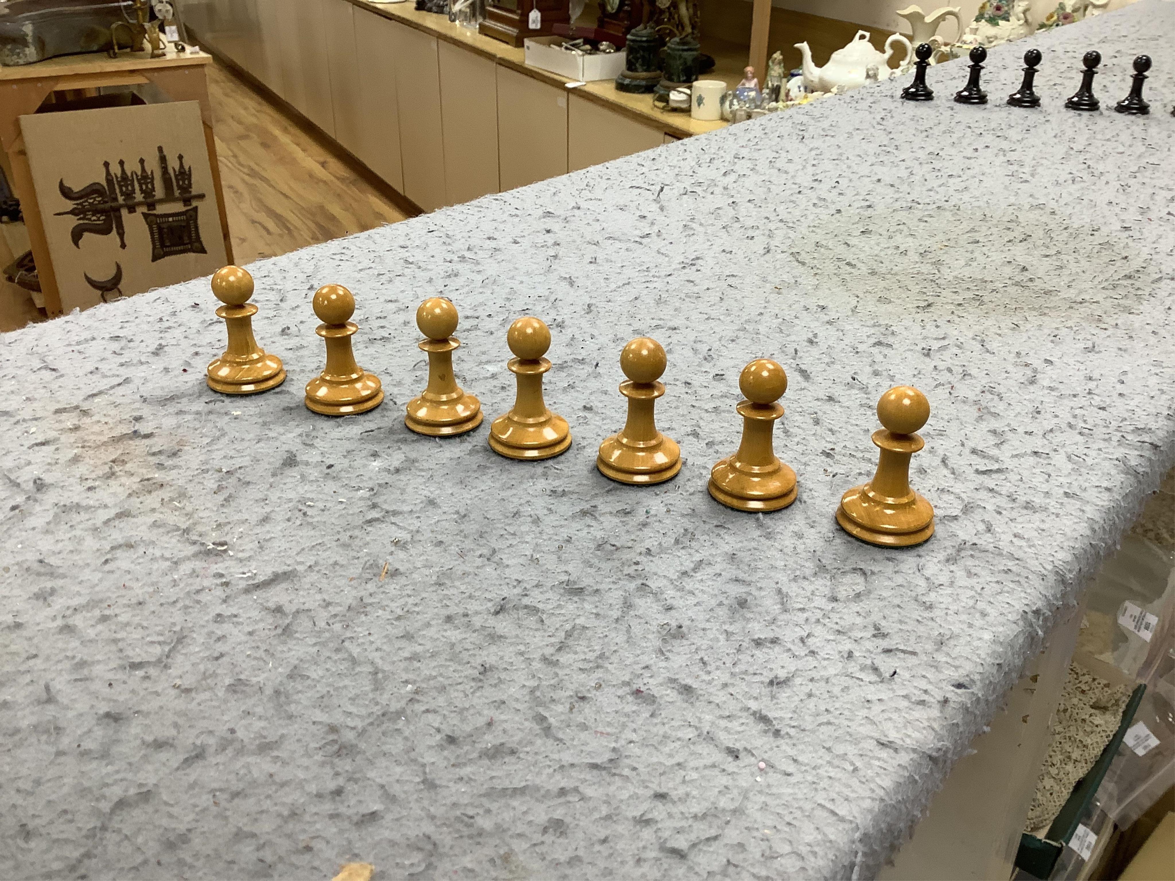 A boxed Jaques Staunton boxwood and ebonised lead weighted chess set, White king stamped Jaques London, Kings 10cm, unlabelled box 20cm wide x 9cm high. Condition - chess pieces good, box cracked